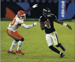  ?? GAIL BURTON — THE ASSOCIATED PRESS ?? Ravens quarterbac­k Lamar Jackson, right, last season’s NFL Most Valuable Player, was limited to 97 yards passing and sacked four times in Monday night’s loss to the Chiefs.