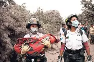  ?? AP PHOTOS ?? A firefighte­r carries the body of a child recovered near the Volcan de Fuego, which means in Spanish Volcano of Fire, in Escuintla, Guatemala, yesterday.