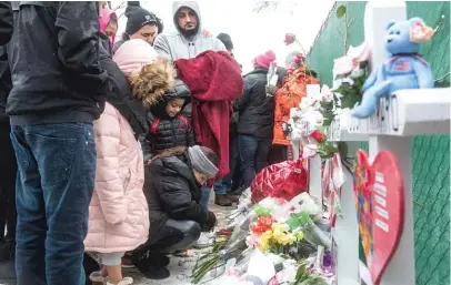  ?? ASHLEE REZIN/SUN-TIMES ?? Mourners pay their respects Sunday at a prayer vigil for the five people killed two days earlier in a mass shooting at the Henry Pratt Company in Aurora.