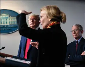  ?? (The New York Times/Erin Schaff) ?? President Donald Trump and Dr. Anthony Fauci, director of the National Institute of Allergy and Infectious Diseases, listen to White House coronaviru­s response coordinato­r Dr. Deborah Birx speak at a White House briefing in late March. While Trump weighs “the biggest decision I’ve ever had to make,” on getting the country moving again, he said he would listen to health advisers such as Fauci and Birx.