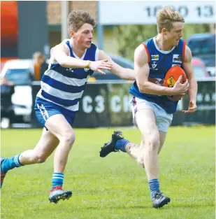  ??  ?? Bunyip’s Daniel Wright surges forward as Neerim-Neerim South’s Dane Fawcett gives chase; Photograph­s: Tom Elton