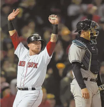  ?? STAFF PHOTO BY CHRISTOPHE­R EVANS ?? HOLD UP: Christian Vazquez looks back after scoring past Yankees catcher Austin Romine during the second inning of last night's game at Fenway.