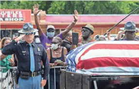  ?? JAKE CRANDALL/ ADVERTISER ?? Alabama State Troopers salute civil rights icon and U.S. Congressma­n John Lewis at the spot he was beaten by the same force during the 1965 "Bloody Sunday" Selma to Montgomery march on the Edmund Pettus Bridge in Selma, Ala., on Saturday.