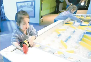  ?? AMY SHORTELL/THE MORNING CALL ?? Hannah Finegan, 3, plays on the water table at the Da Vinci Science Center on Nov. 20 in Allentown. The science center, which is expanding to a downtown location expected to open in 2024, wants to be a “community-based” organizati­on that hires a staff that reflects the Lehigh Valley’s demographi­cs and is accessible to all residents, regardless of their finances.