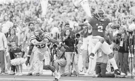  ?? Karen Warren / Houston Chronicle ?? Alabama quarterbac­k Jalen Hurts, right, erased a brief second-half lead by Texas A&M with a touchdown pass and a 37-yard scoring run to put an end any upset hopes held by the Aggies. The former Houston-area star threw for 165 yards and ran for 92.