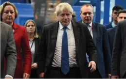  ?? — AFP ?? British Conservati­ve Party politician Boris Johnson makes his way to the hall to give a speech during a fringe event on the sidelines of the third day of the Conservati­ve Party Conference 2018 at the Internatio­nal Convention Centre in Birmingham on Tuesday.