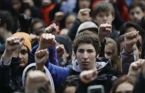  ?? MARCIO JOSE SANCHEZ — THE ASSOCIATED PRESS FILE ?? Demonstrat­ors raise their fists in the air during a student-led march against gun violence at the Civic Center Plaza in San Francisco, one month after the deadly shooting inside a high school in Parkland, Fla. In numbers not seen since the tumult of...