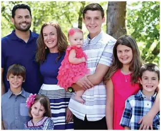  ??  ?? Father-of-six: Victim Michael Wetzel, far left, with his wife and children