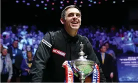  ?? Photograph: Zac Goodwin/PA ?? A delighted Ronnie O’Sullivan shows off the world championsh­ip trophy after his victory against Judd Trump at the Crucible on Monday.