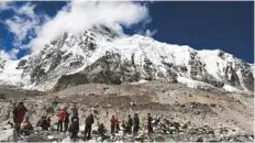  ?? AP ?? Trekkers rest at Everest Base Camp, Nepal. Experts fear novice climbers have raised the risk of icefall on the peak.