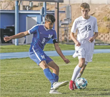  ?? JANE PHILLIPS/FOR THE NEW MEXICAN ?? St. Michael’s Justice Johnson, left, battles Santa Fe Prep’s Sam Little on Saturday in the first round of the Class 1A/3A State Soccer Tournament at Christian Brothers Athletic Complex. Johnson had two goals and an assist as the Horsemen won, 5-0.