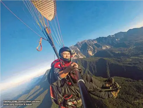  ??  ?? PARAGLIDIN­G antara sukan rekreasi lasak yang menarik di Sabah.