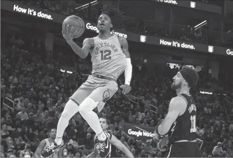  ?? USA TODAY SPORTS ?? Memphis Grizzlies guard Ja Morant rises for a layup against Golden State Warriors guard Klay Thompson during Game 3 of their Western Conference second-round series in San Francisco on May 7.