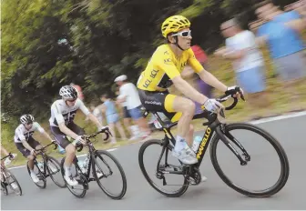  ?? AP PHOTO ?? LEADING THE PACK: Geraint Thomas, wearing the overall leader’s yellow jersey, is followed by teammate and fellow Brit Chris Froome during yesterday’s 14th stage of the Tour de France.