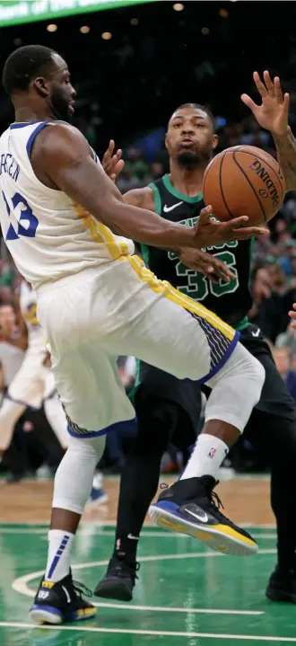  ?? STUART CAHILL / HERALD STAFF FILE ?? PEAS IN A POD: Boston’s Marcus Smart and Golden State’s Draymond Green battle for the ball a year ago in Boston.