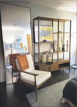  ?? Photograph­s by Myung J. Chun Los Angeles Times ?? IN HIS BEDROOM are an armchair dating back to 1958 and a room divider, both from McCobb’s Planner Group designs. (Mirror was not designed by McCobb.)