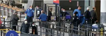  ?? STuART CAHILL / HeRALd sTAFF FILe ?? MASKS UP: Passengers, security staff and gate agents wear masks at Logan Internatio­nal Airport’s Terminal A recently. The CDC has extended mask-wearing rules Until next month.