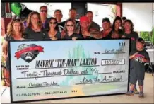  ?? SUBMITTED PHOTO ?? The A-Team nonprofit group presented 11-year-old Maverik Laxton with a check for $20,000at a fundraiser for another of the group’s causes held at Maenner-Chor Club on Sept. 18.