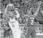  ?? Sue Ogrocki / Associated Press ?? The Thunder’s Paul George, center, was off his game against his former team, scoring 10 points before fouling out against the Pacers.