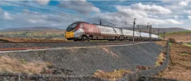  ?? MARTYN FORDHAM. ?? A Virgin Trains Class 390 races through Greenholme (Cumbria) on February 16. 64% of all Britons use rail, according to new figures.