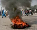  ?? AP ?? supporters of a Pakistani radical group burn tyres in karachi on Wednesday. —