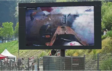  ?? — AFP ?? Scary moment: A giant screen showing the crash of Renault driver Kevin Magnussen during the Belgian Formula One Grand Prix at spa-Francorcha­mps on sunday.