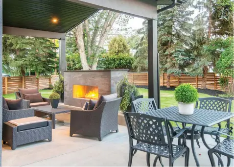  ??  ?? Coloured concrete surfaces warms the covered deck that hosts a builtin fireplace clad in Dekton stone.