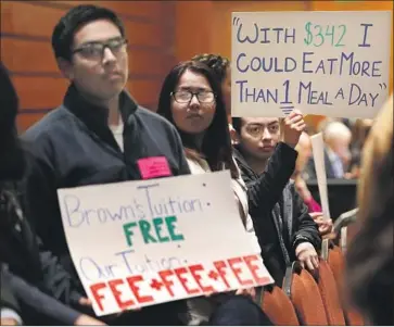  ?? Mel Melcon Los Angeles Times ?? UC BERKELEY students Bryan Osario, left, and Angelica Rodriguez protest a tuition-hike plan during the UC regents meeting Wednesday. The board proposed a $342 increase to bring state residents’ costs to $12,972.