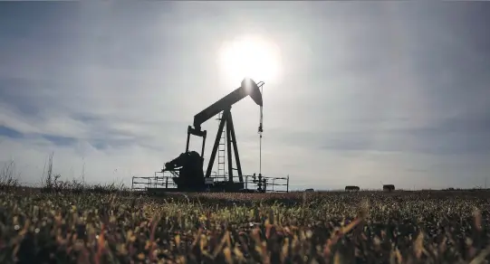  ?? JEFF MCINTOSH/THE CANADIAN PRESS FILES ?? A pumpjack works at a wellhead on an oil and gas installati­on near Cremona, Alta. The National Energy Board’s report forecasts domestic oil production will grow by 58 per cent and natural gas production will grow 29 per cent between now and 2040, while domestic energy demand will increase by just five per cent — or less.