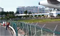  ??  ?? Risky: Tourists grip fence behind airliner in 2012 video