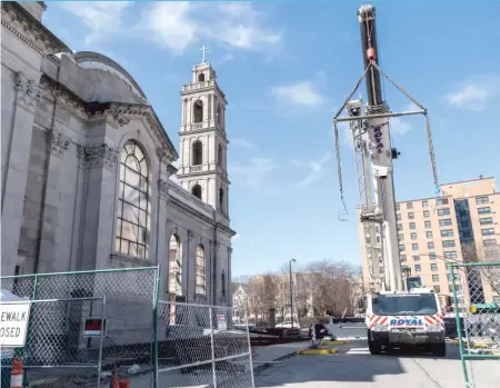  ?? | ERIN BROWN/ FOR THE SUN- TIMES ?? Work has begun to install massive roof trusses at the Shrineof Christ the King Sovereign Priest Catholic church inWoodlawn.