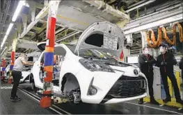  ?? MICHEL SPINGLER Associated Press ?? TWO YEARS of semiconduc­tor shortages and supply problems have kept vehicle production low. Above, a Yaris is assembled in 2020 at a Toyota plant in France.