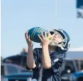  ??  ?? Wyatt Davis, 5, of Branford plays catch with his family.