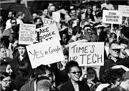  ?? ERIC RISBERG/AP ?? Google employees hold up signs at Harry Bridges Plaza during a walkout Thursday in San Francisco.