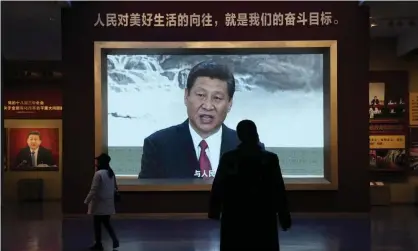  ?? Photograph: Ng Han Guan/AP ?? Xi Jinping on a TV screen under the slogan ‘The people's yearning for a better life is the goalwe strive for’ at the Museum of the Communist party of China in Beijing.