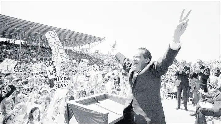  ?? ASSOCIATED PRESS ?? Richard Nixon flashes the victory sign as he acknowledg­es cheers from a crowd in Missouri during his 1968 campaign for president.