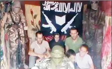  ??  ?? A picture grabbed on a video released by YouTube on Feb 25, shows Tanguy Moulin-Fournier (left), sitting next to his wife, Albane (center, wearing a black veil), his brother Cyril, and their four children flanked by an armed man in an undisclose­d...
