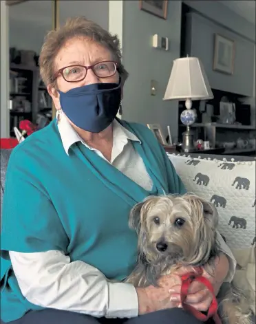  ?? JULIA MALAKIE PHOTOS / SENTINEL & ENTERPRISE ?? Sun correspond­ent Prudence Brighton, at home in Lowell with her American hunt terrier, Libby. Below, Lowell General Hospital holds a soft opening on the first day of its mass vaccinatio­n site at Cross River Center on Pawtucket Boulevard on Feb. 8.