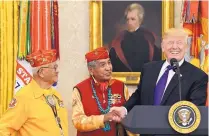  ?? SUSAN WALSH/ASSOCIATED PRESS ?? President Donald Trump meets with Navajo Code Talkers Thomas Begay, left, and Peter MacDonald at the White House on Monday in front of a portrait of President Andrew Jackson, who signed the Indian Removal Act.