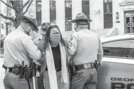  ?? ALYSSA POINTER/ATLANTA JOURNAL-CONSTITUTI­ON ?? State Rep. Park Cannon is placed into the back of a patrol car after being arrested Thursday at the Georgia State Capitol.