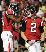  ?? Kevin C. Cox / Getty Images ?? Falcons QB Matt Ryan (2) and Aldrick Robinson celebrate a second-quarter TD connection.