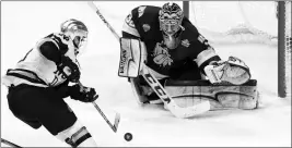  ?? ASSOCIATED PRESS ?? MINNESOTA DULUTH GOALIE HUNTER SHEPARD (32) stops a shot by Notre Dame right wing Colin Theisen (13) in the second period during a Frozen Four championsh­ip college hockey game, Saturday in St. Paul, Minn.