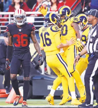  ?? Scott Strazzante / The Chronicle ?? Los Angeles’ Todd Gurley (30) and Jared Goff celebrate a Gurley’s third touchdown of the first half, giving the Rams a 24-13 lead over the 49ers and Dontae Johnson (36).