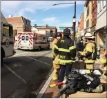  ?? EVAN BRANDT — MEDIANEWS GROUP ?? Firefighte­rs gather outside the mobile incident command center provided by Montgomery County and parked in downtown Pottstown Friday morning.