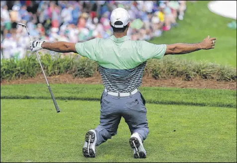  ?? CURTIS COMPTON / CCOMPTON@AJC.COM ?? Tiger Woods reacts as he just misses a hole-in-one on the eighth hole during the Par 3 tournament Wednesday. Woods is attempting a comeback in a major he has won four times, the first time when he was 21.