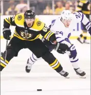  ?? Maddie Meyer / Getty Images ?? Boston’s Brad Marchand, left, battles Kasperi Kapanen for control of the puck during the second period on April 25.