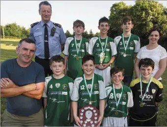  ?? Photo by: John Reidy FRONT: BACK: ?? Gamers FC, winners of the fifth and sixth class title. Tony Nolan, manager; Josh Elvins; Finn Nolan, captain; Eoghan Shire and Patrick O’Shea. Sgt John O’Mahony, event founder; Billy Walsh; Ruairí Bourke; Thomas Conway; and Helena Falvey, KDYS Youth...