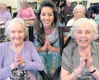  ??  ?? ●●Residents Betty Henshaw (left) and Joyce Hammond at the Bollywood event with Ria Meera Munshi