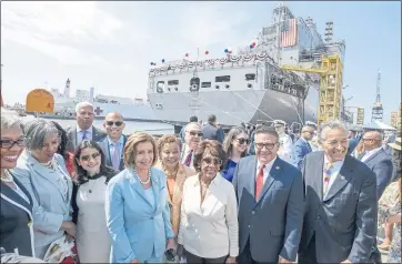  ?? DENIS POROY — THE ASSOCIATED PRESS ?? Speaker of the House Nancy Pelosi, center, poses with dignitarie­s in front of the Navy ship John Lewis after a christenin­g ceremony Saturday in San Diego.