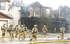  ?? JIM WELLS ?? Calgary firefighte­rs battle a multiple alarm house fire on Copperfiel­d Blvd SE in Calgary on Sunday. Two houses were destroyed and another two were damaged in the blaze. There were no reports of injury.